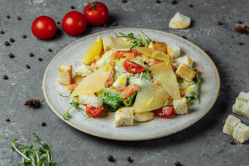 Caesar salad with salmon and fresh vegetables. Top view. Free space for your text
