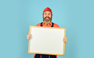 man with presentation. Builder points to flipchart. Architect Worker hold Flip Chart. Conference Meeting. person presenting at a flip-chart. Businessman. male construction worker. copy space