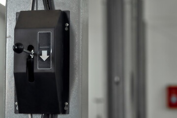 Close up of hoist up and down switch button in car garage. Car service, repair, maintenance concept