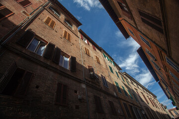 Siena, Italy - 12/09/2013: Warm colors of a street of medieval Siena Tuscany