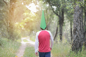 Gnome walking backwards along a forest path.