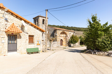 Fototapeta na wymiar a street in Cubillejo de Lara (Mambrillas de Lara) with the parish church, province of Burgos, Castile and Leon, Spain