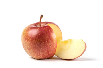 Whole and slices red apples on white