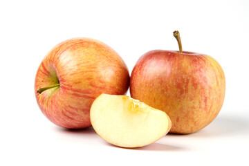 Whole and slices red apples on white