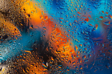 Colorful background with raindrops, blurred style. Bright tints of blue and orange colors, trendy...
