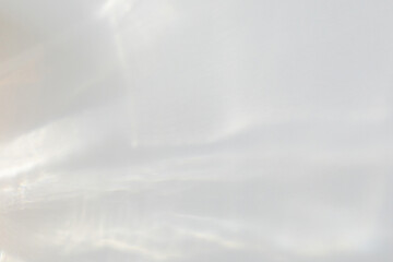 Fototapeta premium Water texture overlay effect for photo and mockups. Organic drop diagonal shadow and light caustic effect on a white wall. Shadows for natural light effects