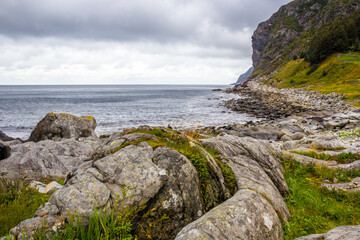 Fototapeta na wymiar rainy clouds over the Kannesteinen rock on the coast of Norway