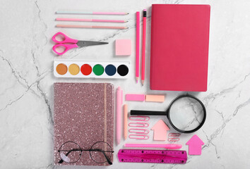 Notepad and bright school stationery on the table. View from above. Flat lay