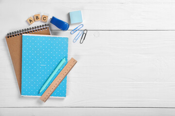 School notebook and various stationery on a white background. Training concept
