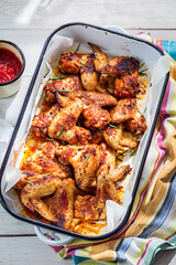 Top view of roasted chicken wings with barbecue sauce