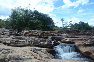 Naklejka na ściany i meble River to the Waterfall in Milho Verde in the state of Minas Gerais called Cachoeira do Moinho (translated to Watermill Waterfall)