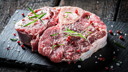 Red meat with pepper and rosemary on stone plate