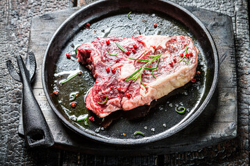Piece of red meat with pepper and rosemary