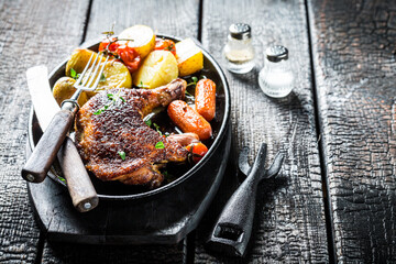 Grilled chicken leg with herbs on metal plate