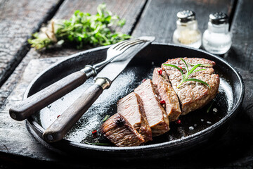 Closeup of beef with fresh herbs ready to eat