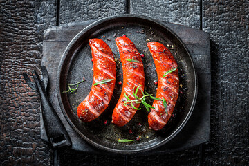 Top view of roasted sausage with fresh herbs