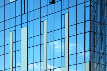 Glass office building, view of the sky reflected in the windows. Concept for work, business, offices. Copy space.