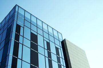Glass office building, view of the sky reflected in the windows. Concept for work, business, offices. Copy space.