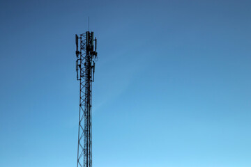 cell tower, silhouette against the blue sky. Communication concept, next generation networks.