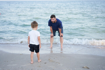 Father son spending time together sea vacation Young dad child little boy walking beach