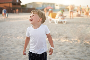 Caucasian boy standing beach. Childhood summertime. Family vacation