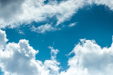 White clouds against the blue sky. Cloudy landscape. Sunny day fluffy clouds