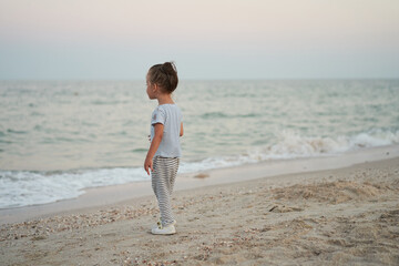 Child playing sand beach Little girl play sad alone summer family vacation