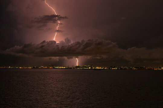 lightning strikes through the cloud into the chimney of the factory, Singapore 2020