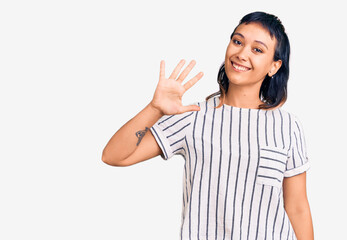 Young woman wearing casual clothes showing and pointing up with fingers number five while smiling confident and happy.