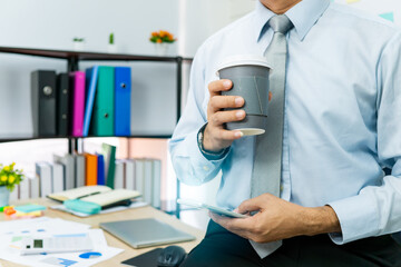 Professional Business man hand hold drink fresh coffee in paper cup glasses morning refreshing coffee break before working meeting computer smartphone mobile