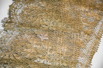 Beautiful textured surface of hand-woven retro lace for garment decoration. The beginning of the 20th century