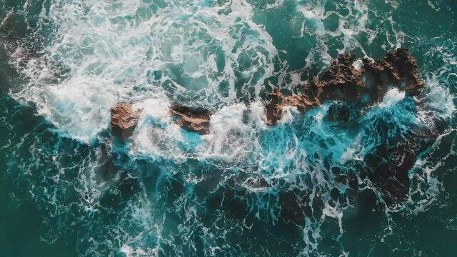 4k UHD 30fps top down drone aerial view of ocean waves splash against rock, Capitolo, Puglia, Italy - Teal Orange grading