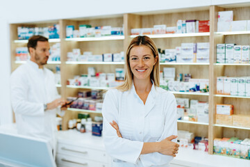 Fototapeta na wymiar Male and female pharmacists working together at modern pharmacy.