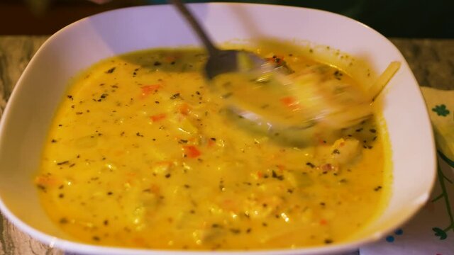 Aromatic fish curry soup chowder blend with atlantic prawns served