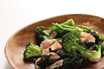 Chinese food, bacon and broccoli stir fried on wooden plate