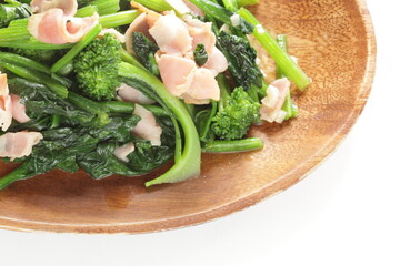 Chinese food, bacon and broccoli stir fried on wooden plate