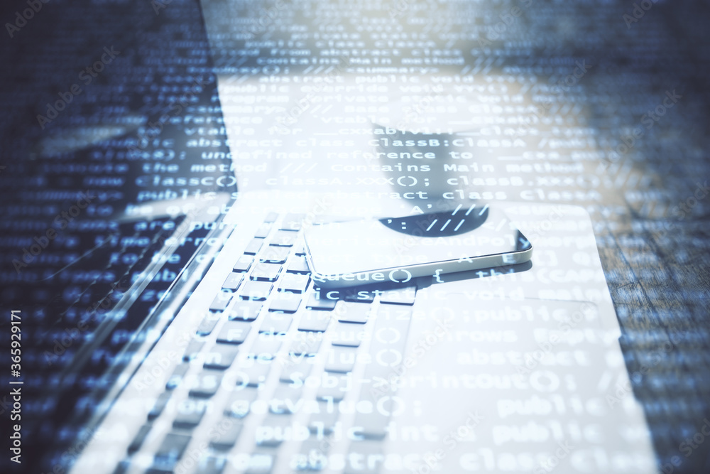 Aufkleber Laptop and smartphone on table with coding backdrop with text.