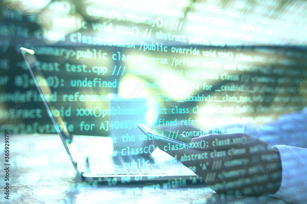 Leinwandbilder Hand using laptop and abstract coding text interface on screen.