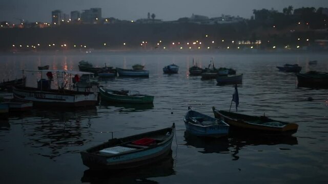 Fisher boats floating at dawn in the city of Lima, Peru.