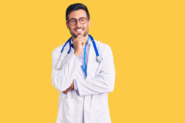 Young hispanic man wearing doctor uniform and stethoscope looking confident at the camera smiling...