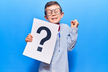 Cute blond kid wearing nerd bow tie and glasses holding question mark screaming proud, celebrating...