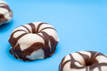 White and Brown donuts on blue background