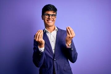 Young handsome business man wearing jacket and glasses over isolated purple background doing money gesture with hands, asking for salary payment, millionaire business