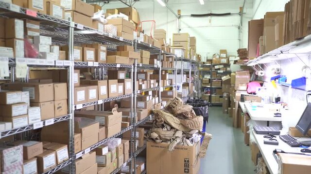 Gliding through an aisle in a warehouse full of products.