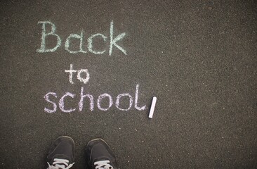 Education, back to school concept.Chalk inscription Back To School on the schoolyard.Top view with copy space.