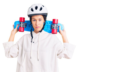 Beautiful brunette young woman wearing safety helmet and skate thinking attitude and sober expression looking self confident