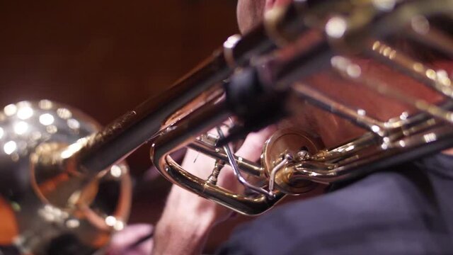 orchestra musician playing trombone slow motion	
