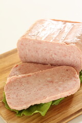 luncheon meat sliced prepared ingredient on wooden board