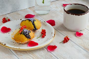 Fresh morning coffee with homemade cupcakes and a pleasant home atmosphere. A cup of coffee with rose petals