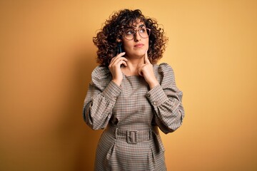 Beautiful arab businesswoman wearing glasses having conversation talking on smartphone serious face...